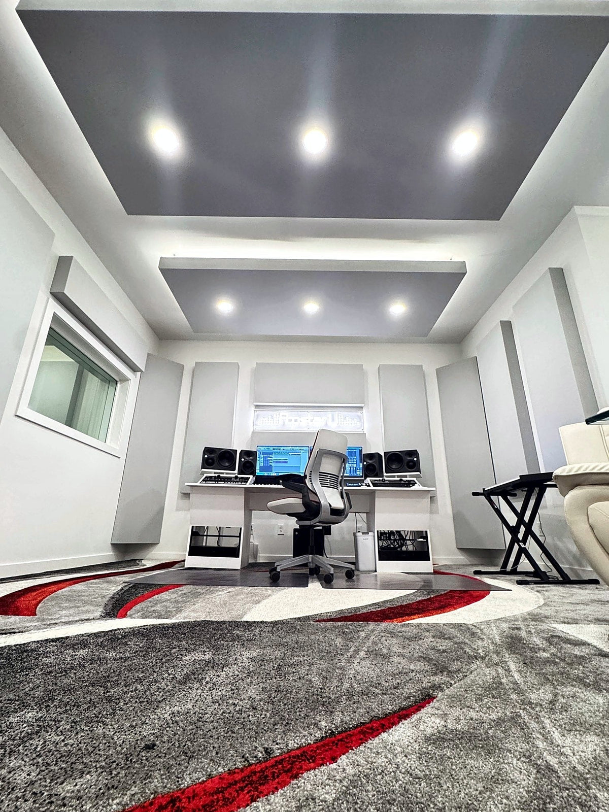Las Vegas recording studio control room with two lit ceiling clouds and gray fabric wall panels