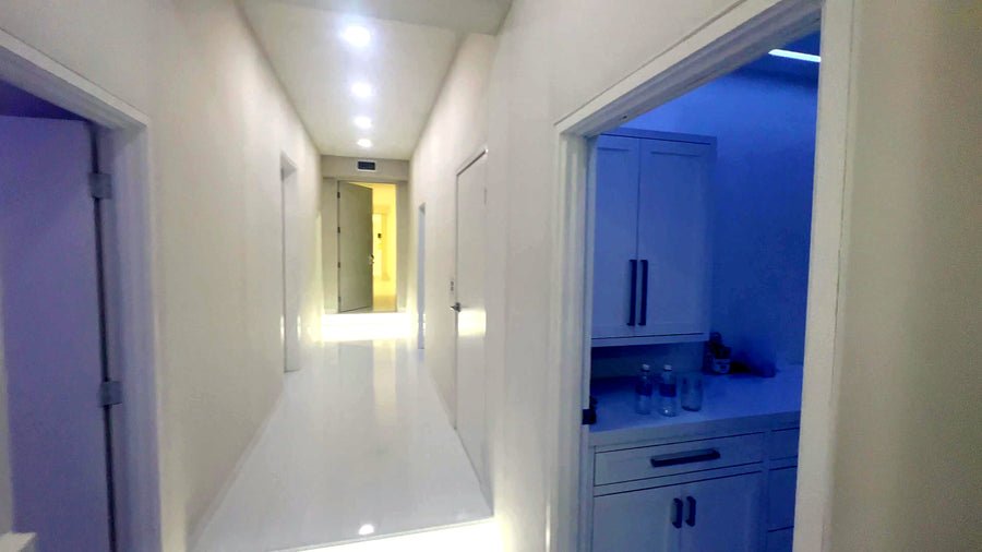 White hallway connecting the rooms of the Calabasas studio