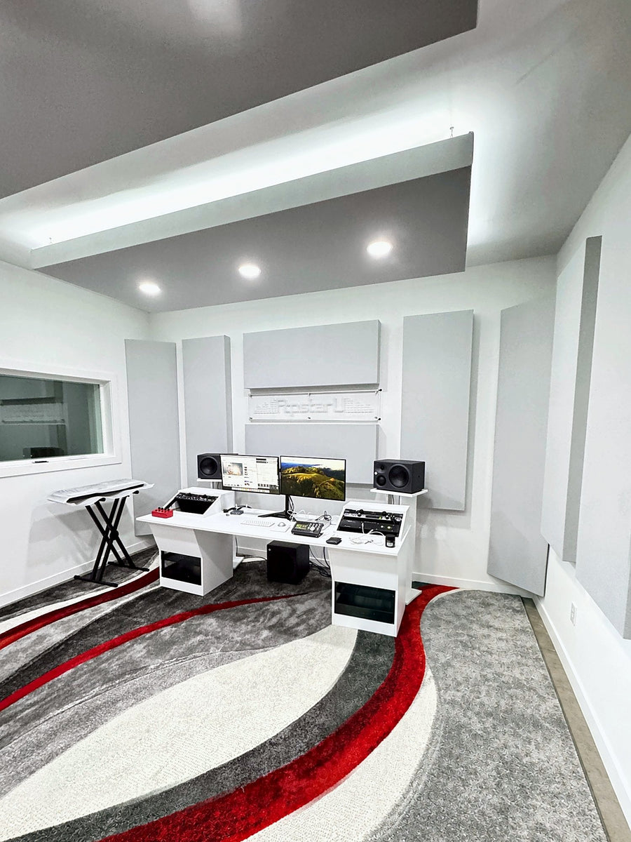 Finished front wall with acoustic panels and the custom white studio desk