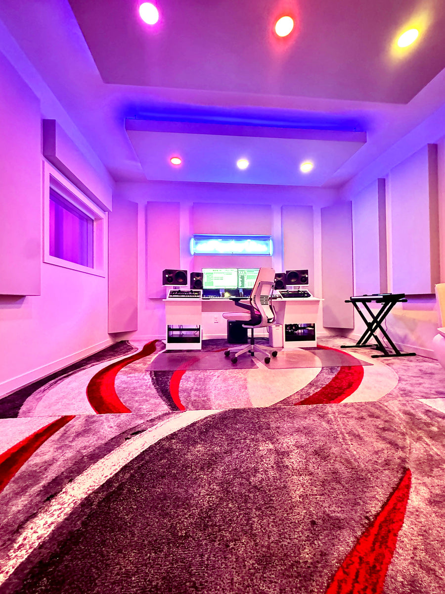 Production suite with a violet lit ceiling cloud, fabric wall panels and a white desk