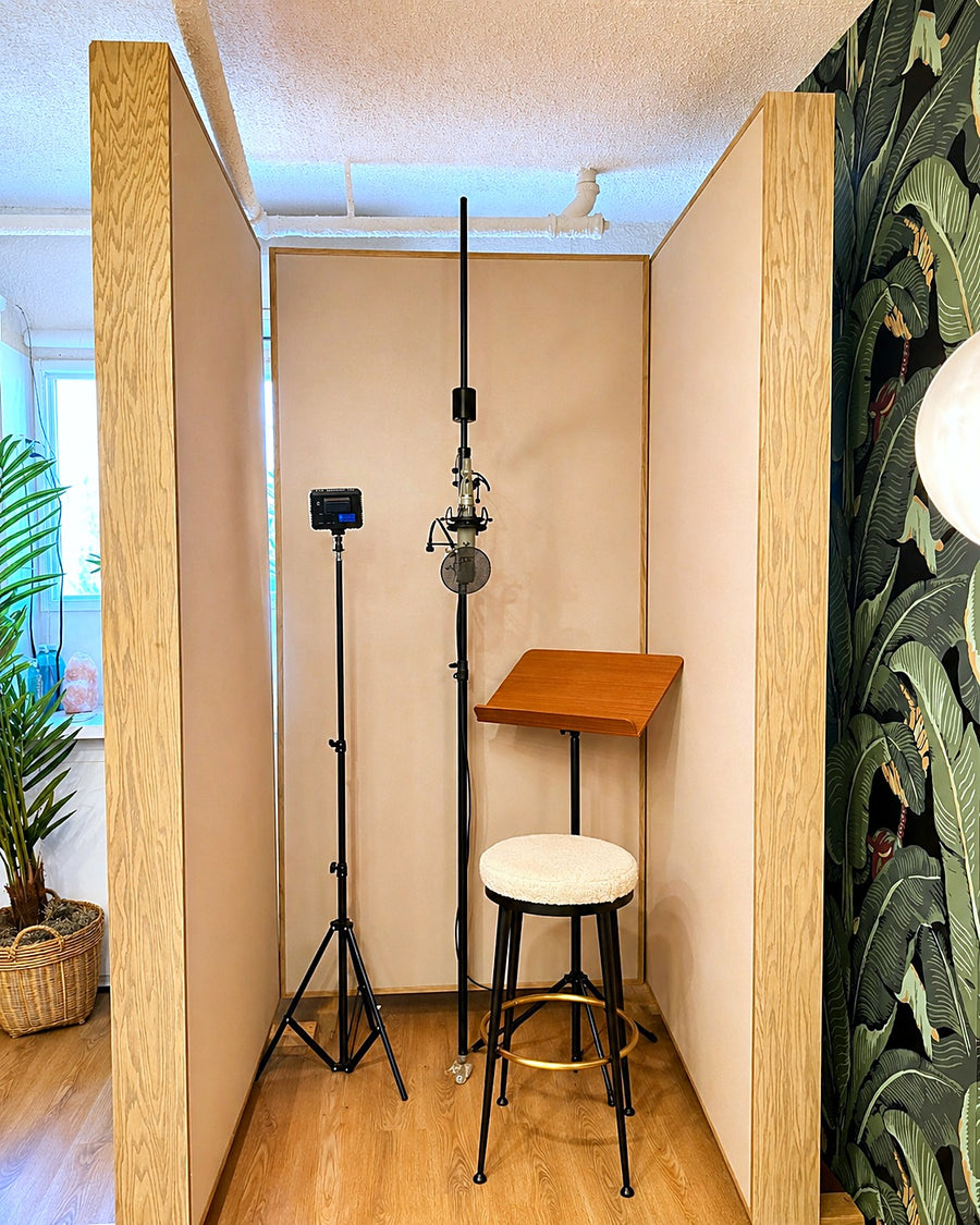 Compact vocal booth made from three wood-framed free-standing gobos, with a microphone and music stand inside
