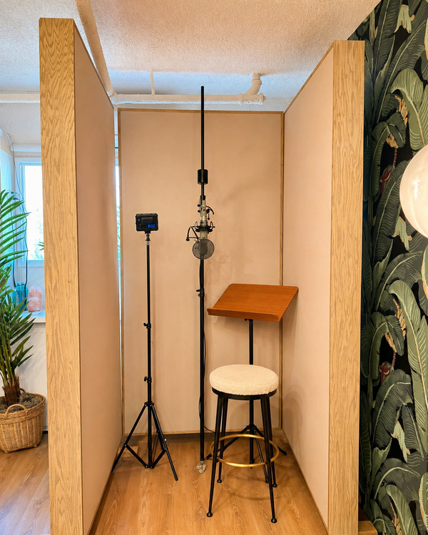 Compact vocal booth made from three wood-framed free-standing gobos, with a microphone and music stand inside